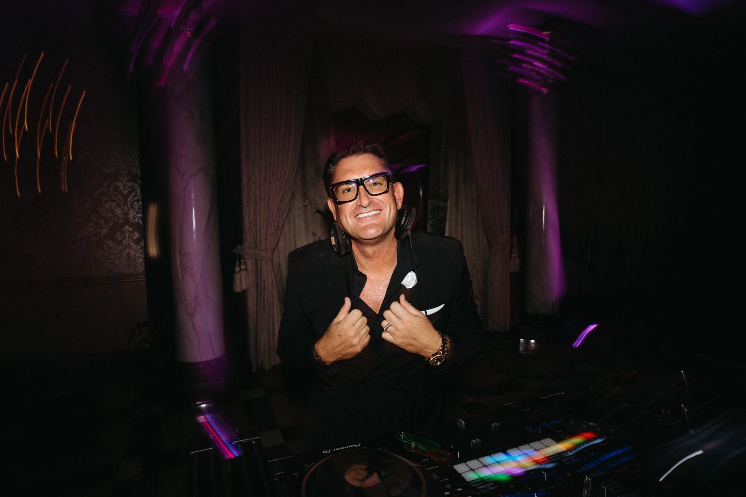 Jason Jani behind the decks under purple light