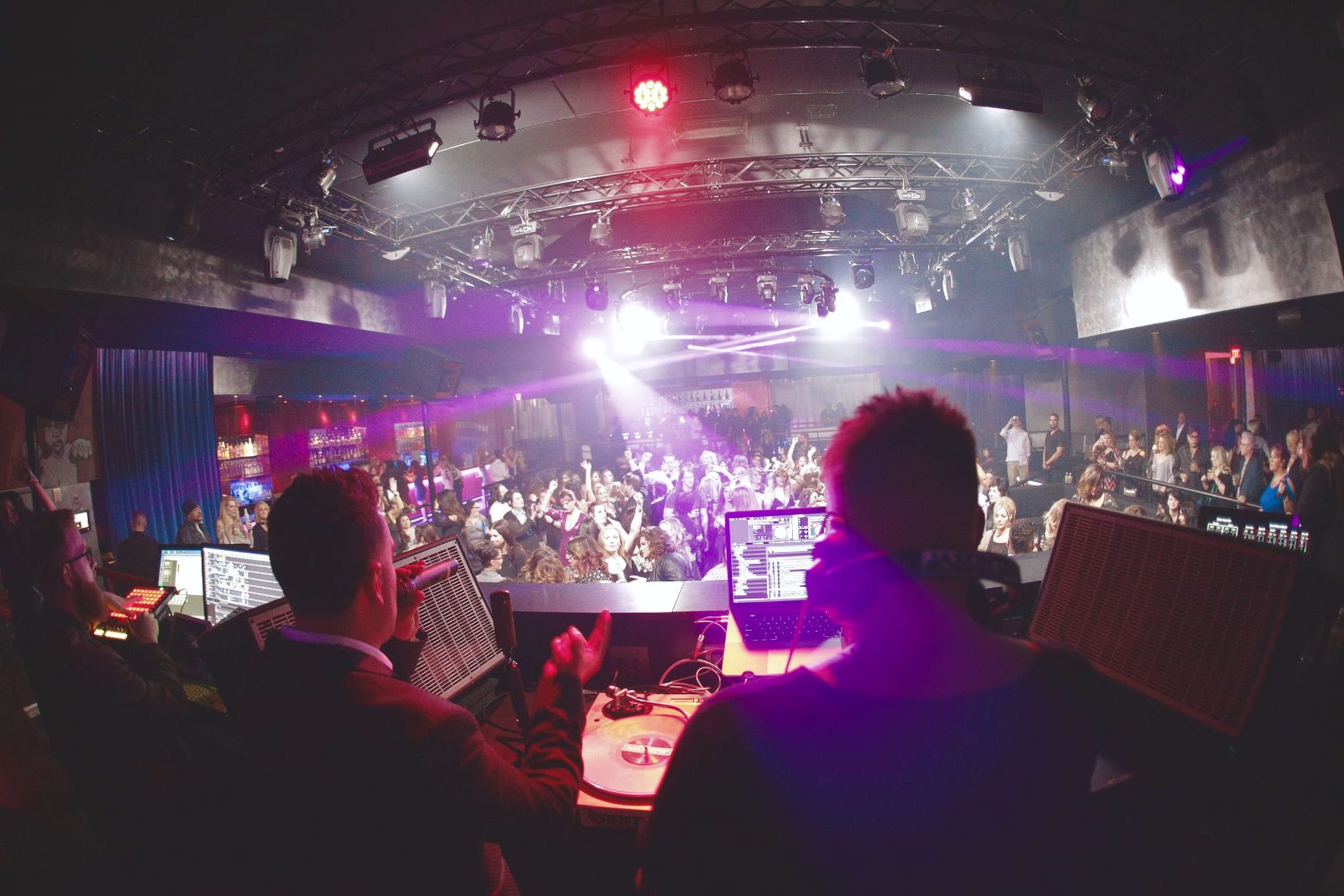 Jason Jani playing a packed venue from the booth