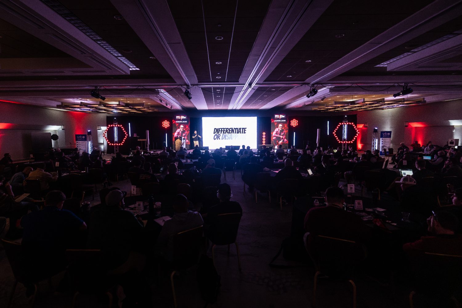 Jason Jani speaking on stage at a DJ industry conference
